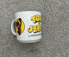 Vintage Tom & Jerry ceramic mug featuring classic artwork of Tom and Jerry