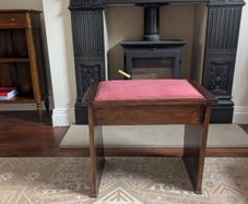 Antique piano stool with pink upholstered seat
