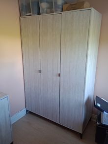 Three-door wardrobe in light wood effect finish