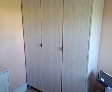 Three-door wardrobe in light wood effect finish