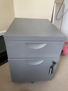 Grey lockable filing cabinet on castors