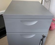 Grey lockable filing cabinet on castors