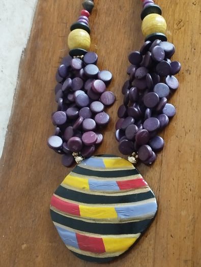 Vintage spectacular necklace made of wooden beads and medallion.