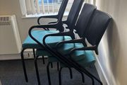 Office chairs with black frames and teal seats