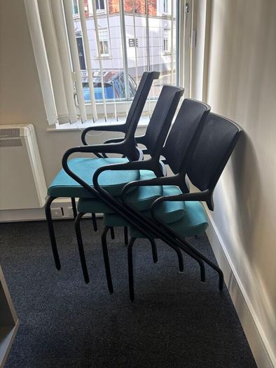 Office chairs with black frames and teal seats