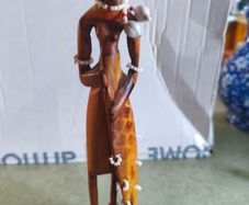 Vintage African wooden figurine of a Maasai warrior in traditional costume
