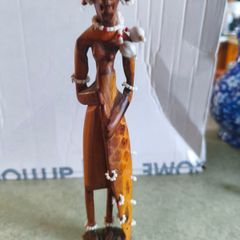 Vintage African wooden figurine of a Maasai warrior in traditional costume