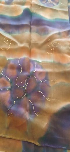 Hand painted, 100% silk scarf featuring a hand-rolled hem and custom metallic gutta detailing.