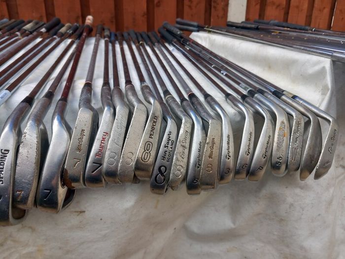 A selection of Golf clubs. Bags and golf balls.
