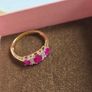 Beautiful yellow gold ring featuring three stunning rubies surrounded by sparkling cubic zirconia stones. Size M, in beautiful condition. Image 9