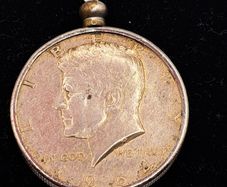 1964 Kennedy half dollar coin in a mounted pendant