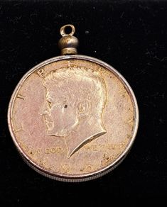 1964 Kennedy half dollar coin in a mounted pendant