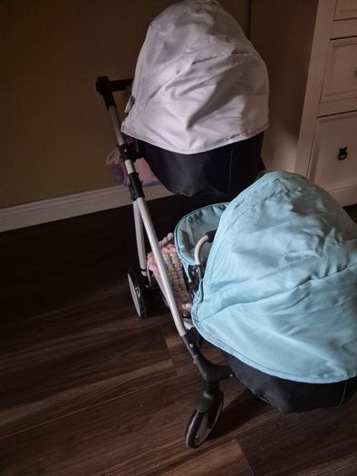 Twin pram and changing bag and 3 dolls