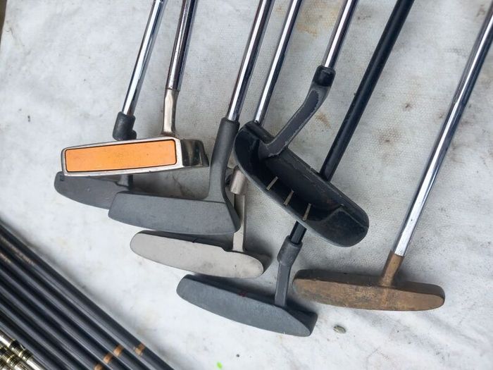 A selection of Golf clubs. Bags and golf balls.