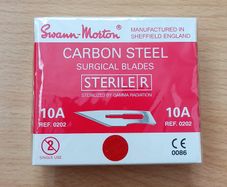 Box of Swann-Morton carbon steel sterile surgical blades manufactured in Sheffield, England, containing 100 individually foil-peel-packed blades protected with VPI