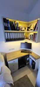 Office desk with wall hung shelving unit with LED lighting