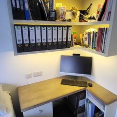 Office desk with wall hung shelving unit with LED lighting