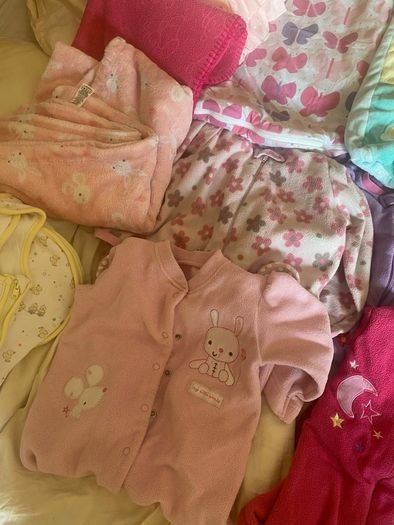 10 all in ones, 3 baby sleep bag, 4 pink blankets