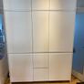 Modern white kitchen units and tall larder storage Image 2