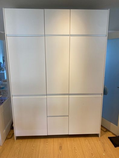 Modern white kitchen units and tall larder storage