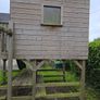 Wooden playhouse with slide and swings Image 5
