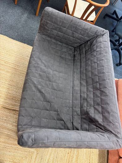 Grey quilted sofa with white metal frame
