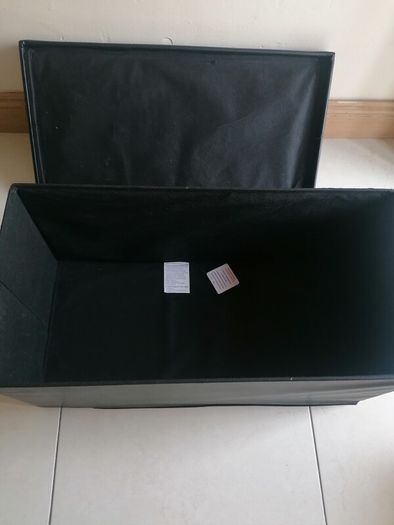 Black faux-leather folding storage ottoman