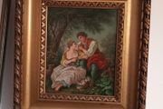 Gilt framed painting of a couple in rural scene.