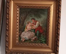 Gilt framed painting of a couple in rural scene.