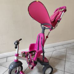 Pink toddler trike with parent handle and canopy