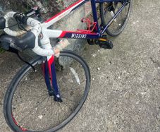 2 boys racing bikes. 1 adult ladies bike.