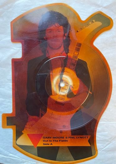 Rare and collectible Gary Moore and Phil Lynott special 2 in 1 shaped picture disc. Out in the fields and military man. Bought this new back in the day. Records were never played but picture disc discoloured over time as all versions did. Still highly col