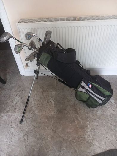 A selection of junior golf clubs and bag.