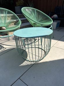 Marks & Spencer Lois garden furniture set in sage green, comprising two armchairs and a matching round table.