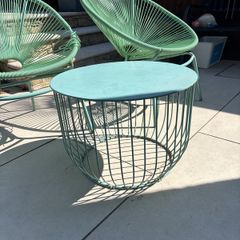 Marks & Spencer Lois garden furniture set in sage green, comprising two armchairs and a matching round table.