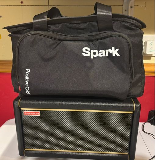 Positive Grid Spark 2 Smart Guitar Amp Bluetooth Speaker, Black with additional battery and carry bag.