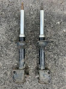 Left & Right hand front suspension strut/shock absorber from a Subaru.