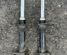 Left & Right hand front suspension strut/shock absorber from a Subaru.