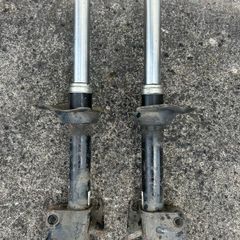Left & Right hand front suspension strut/shock absorber from a Subaru.