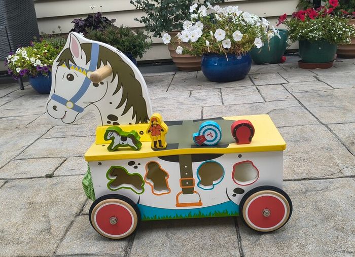 Wooden horse-themed ride-on toy in good used condition