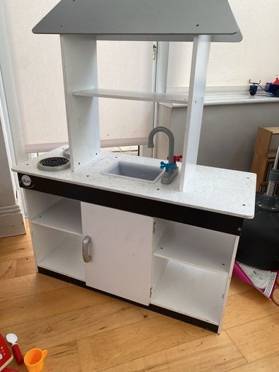 kids play kitchen by Plum with wooden food accessories