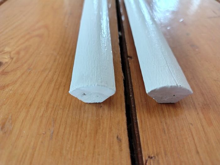 Two 2.4m lengths of white wooden moulding 10x10mm