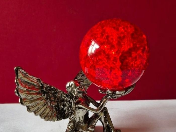 Crackle glass ball and metal angle base.