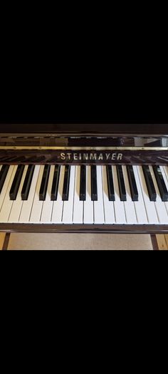 Steinmayer upright piano and stool perfect condition