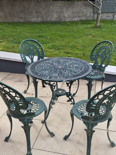 Cast metal garden table and four chairs