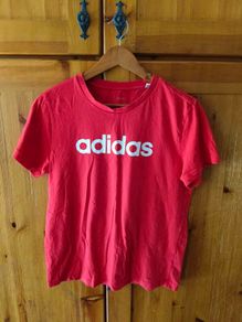 red Adidas t-shirt features a prominent white logo on the chest. Great condition.