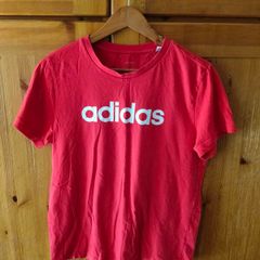 red Adidas t-shirt features a prominent white logo on the chest. Great condition.