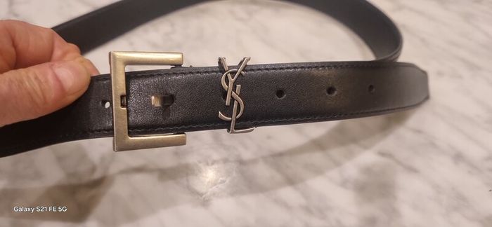 Black leather belt in the style of designer