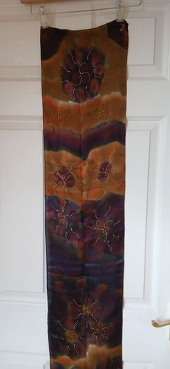 Hand painted, 100% silk scarf featuring a hand-rolled hem and custom metallic gutta detailing.