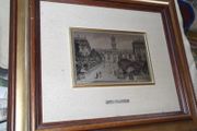 a picture with a silver plaque in the centre